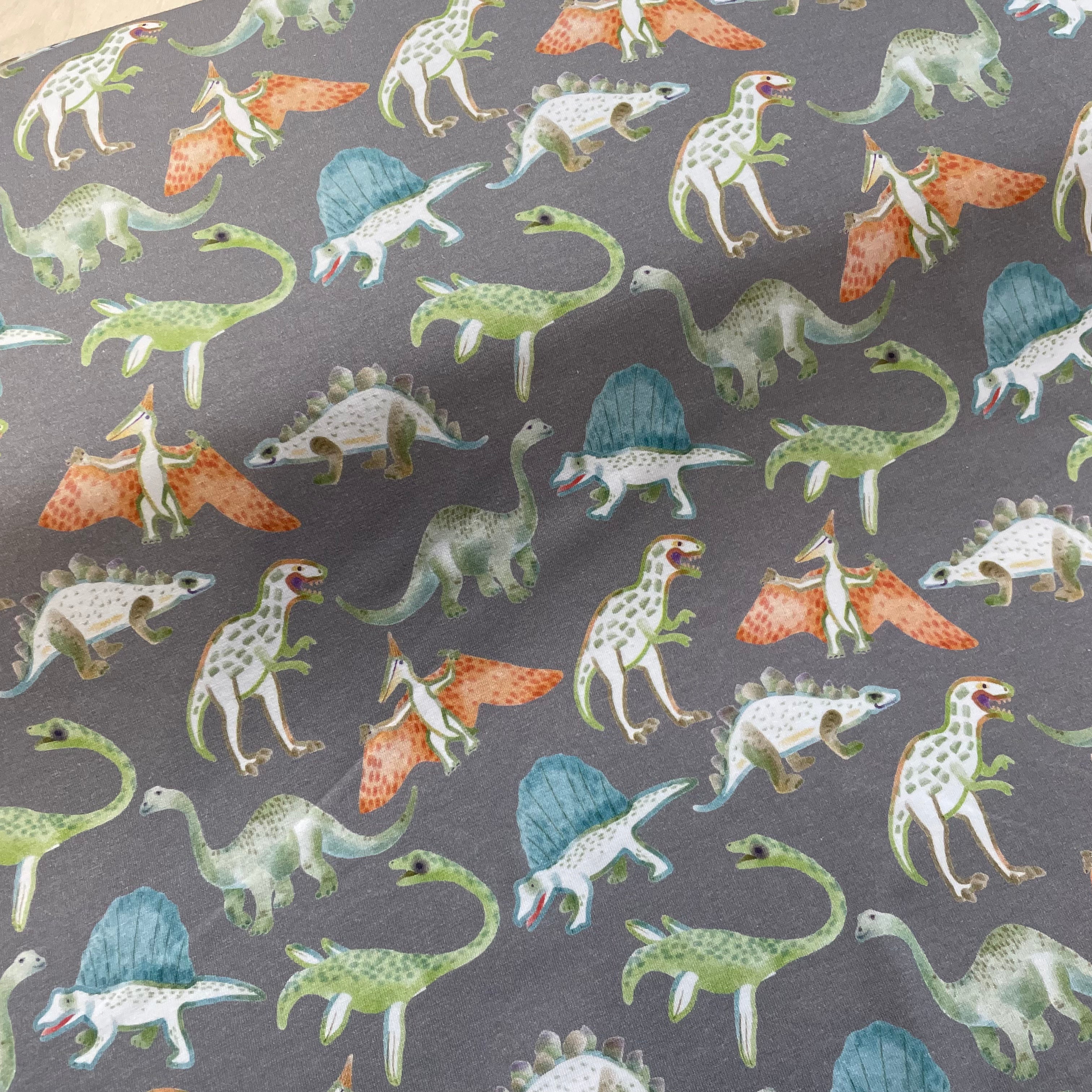 Playful Dinosaurs on Grey Cotton Jersey Fabric